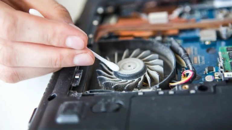 Person-cleaning-dust-out-of-a-laptop