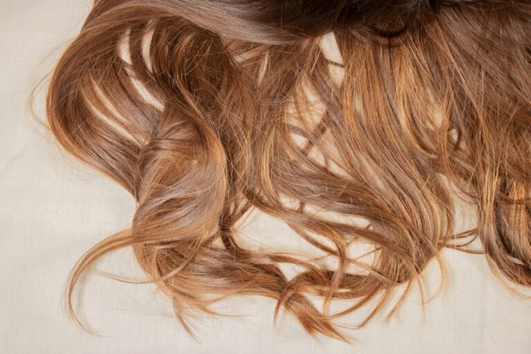 Close-up of flowing brown hair on a light background
